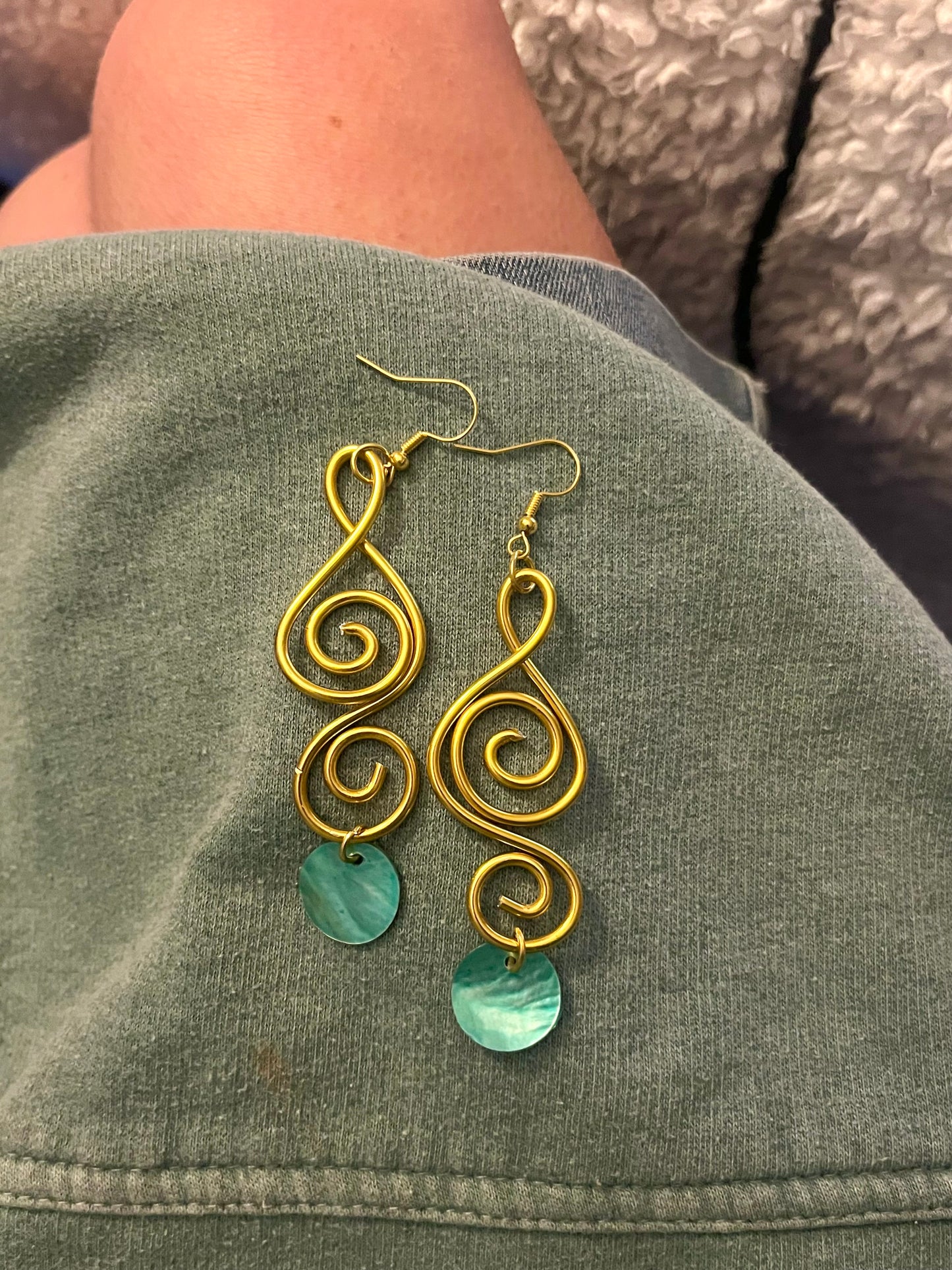 A aqua sister pair of gold swirls
